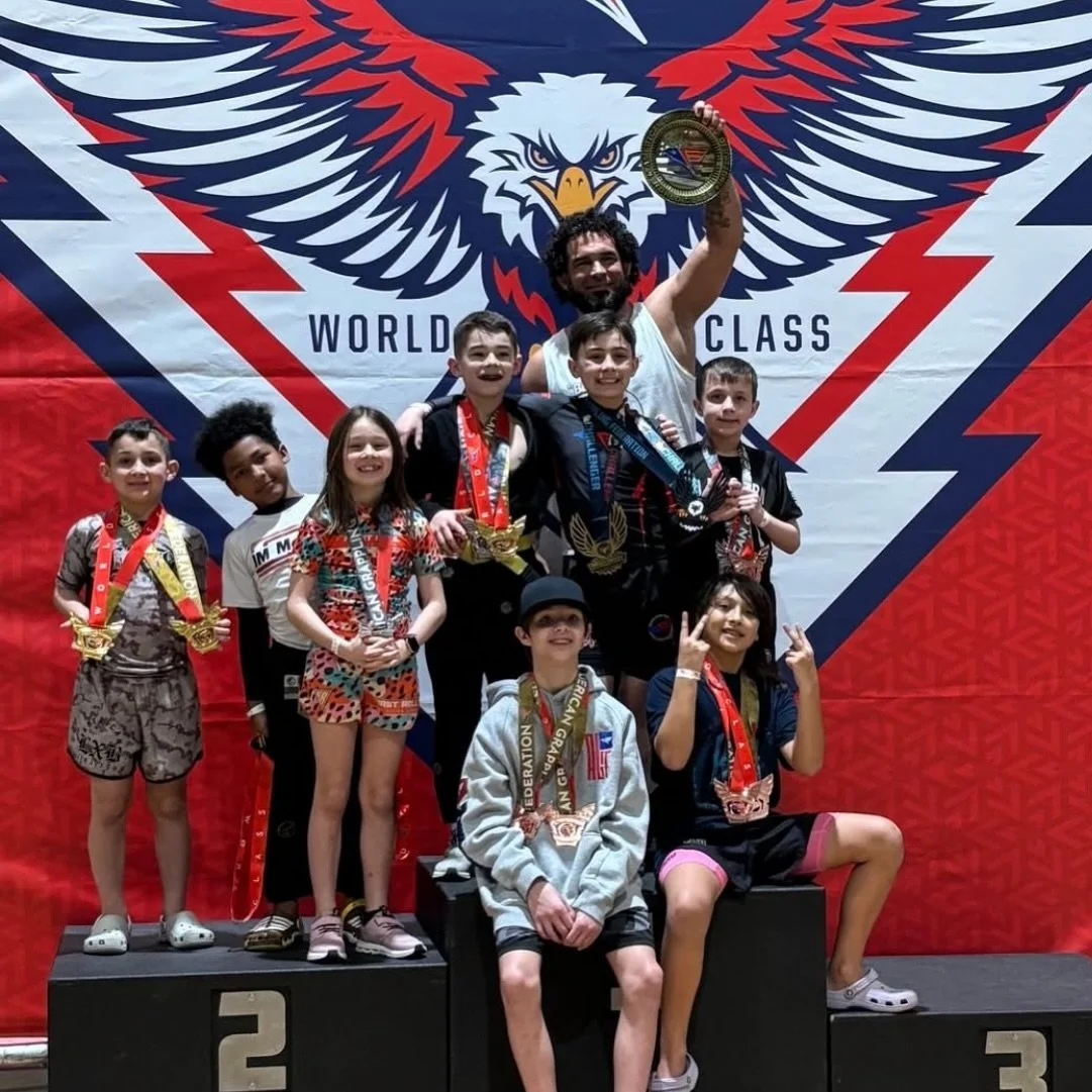 Young students with medals after a grappling tournament